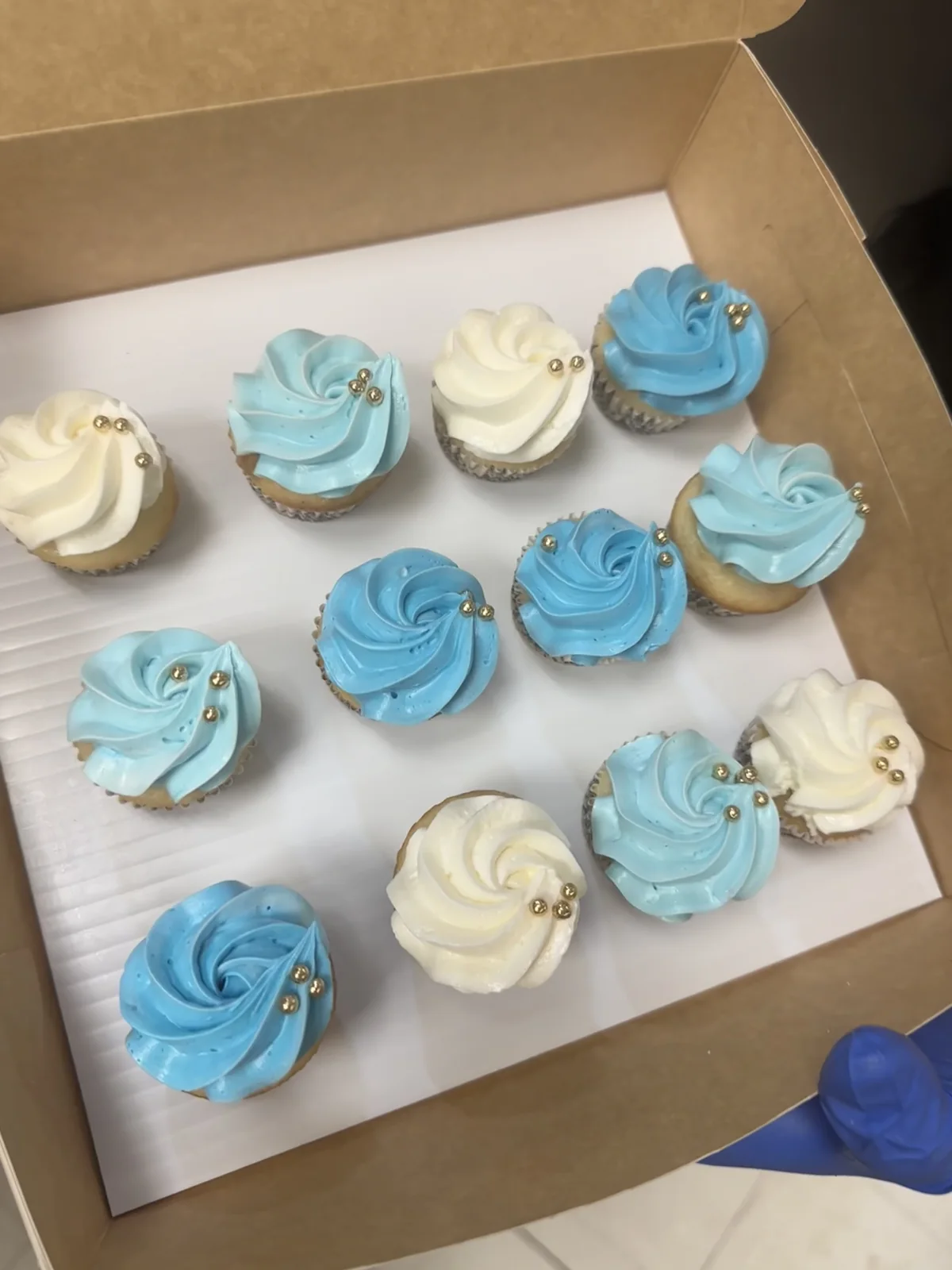 Blue and white decorated baby shower cupcakes